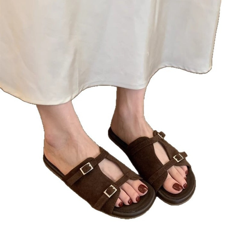 Korean version of niche hollow belt buckle flat bottom one-word open-toe cool slippers women's 2025 new casual vacation sandals