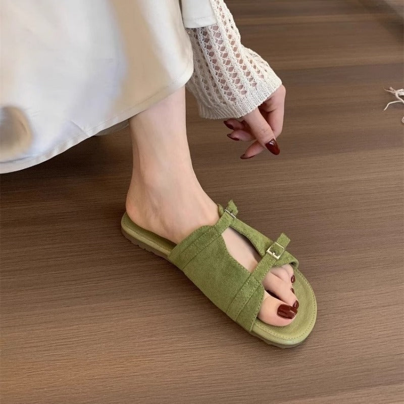 Korean version of niche hollow belt buckle flat bottom one-word open-toe cool slippers women's 2025 new casual vacation sandals