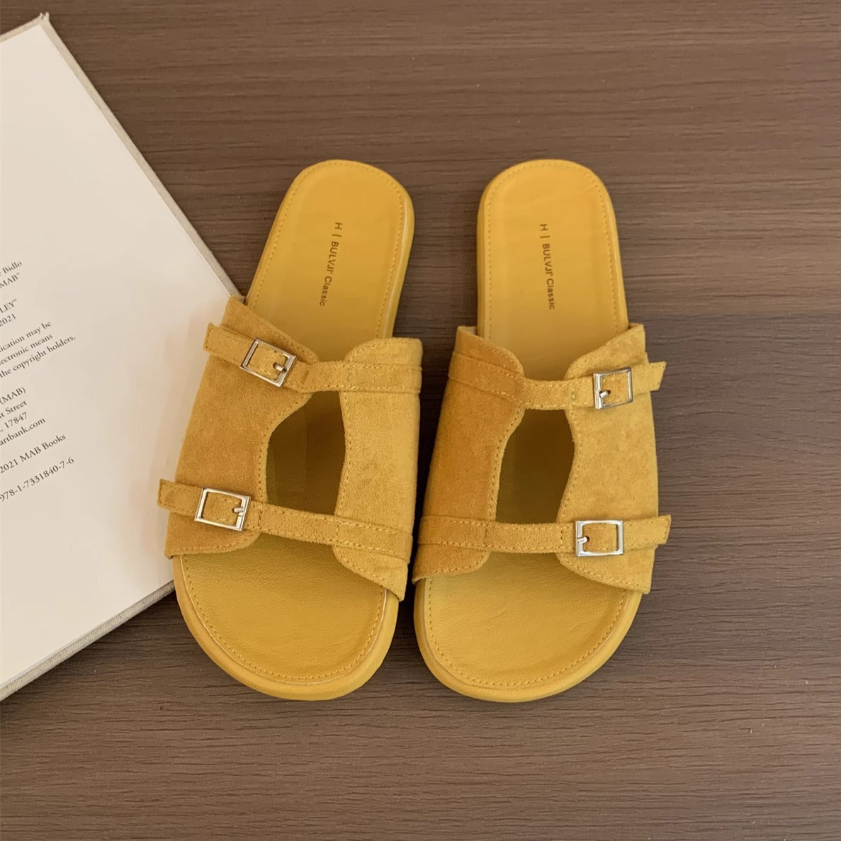 Korean version of niche hollow belt buckle flat bottom one-word open-toe cool slippers women's 2025 new casual vacation sandals